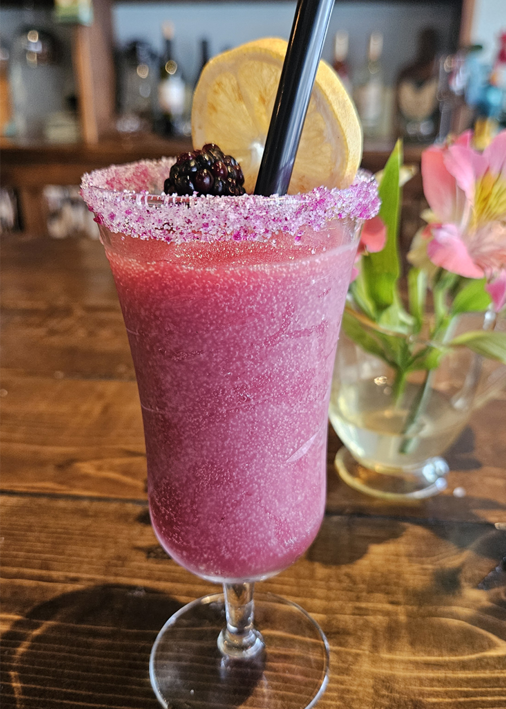 Blackberry wine slushie with a sugared rim